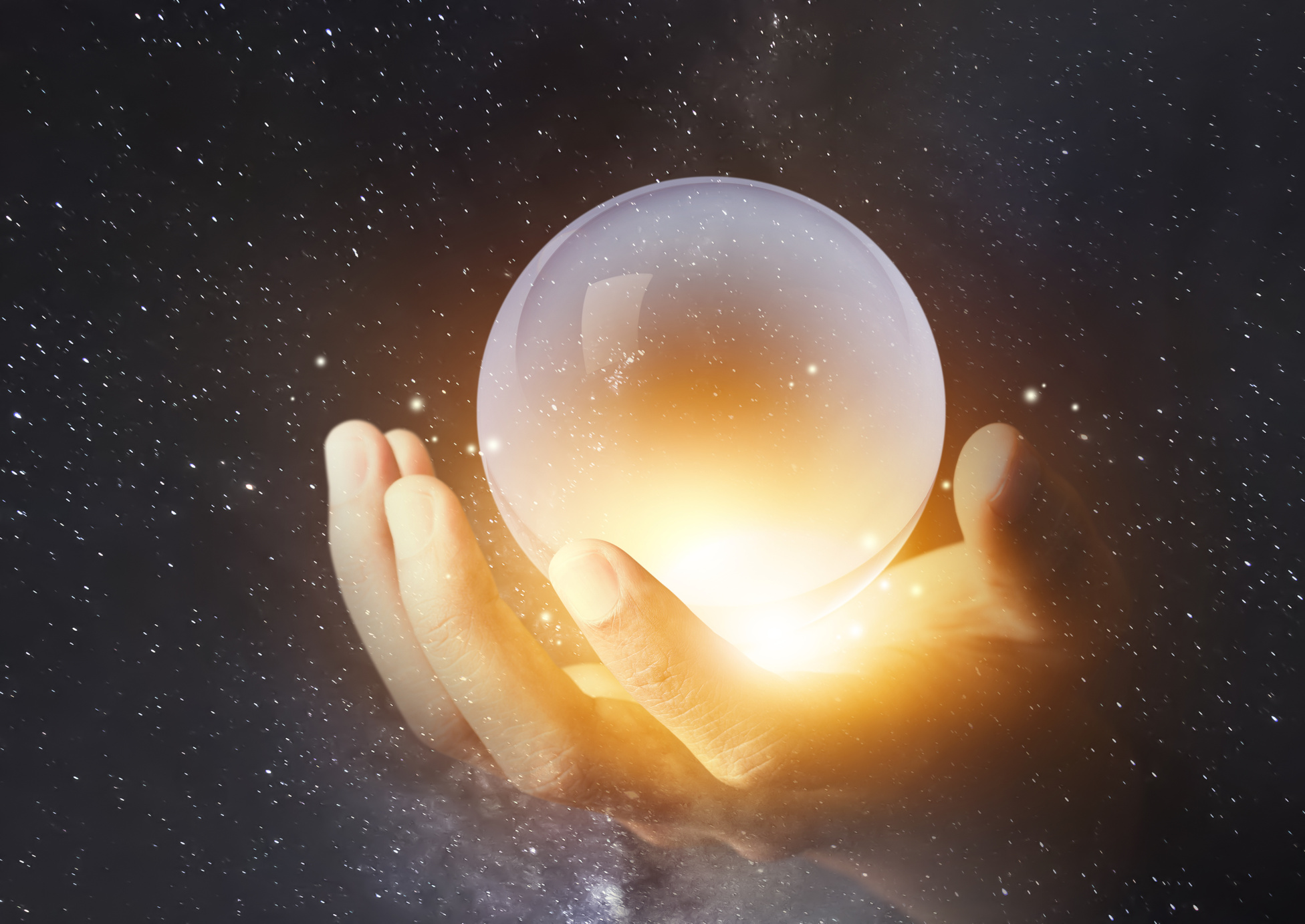 businessman hand holding crystal clear ball with galaxy universe space background